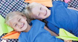 boy and girl with paper planes